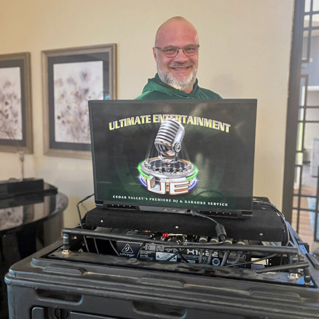 A man smiles with his equipment at Ultimate Entertainment, a local DJ and karaoke business.